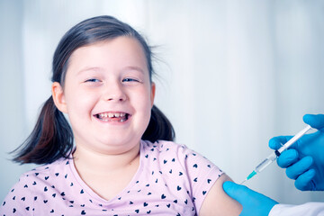 Vaccination concept. Male doctor vaccinating cute little girl in clinic.