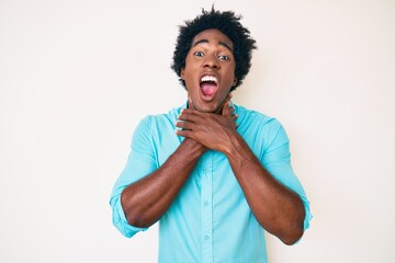 Poster - Handsome african american man with afro hair wearing casual clothes shouting and suffocate because painful strangle. health problem. asphyxiate and suicide concept.