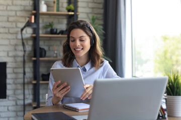 Freelance business women using tablet working call video conference with customer in workplace at home.