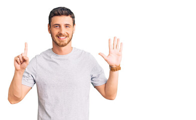 Handsome young man with bear wearing casual tshirt showing and pointing up with fingers number six while smiling confident and happy.