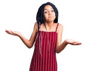 Canvas Print - Cute african american girl wearing casual clothes clueless and confused expression with arms and hands raised. doubt concept.