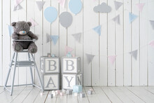 Word Baby On Wooden Cubes Near Toys And Decorated Wall