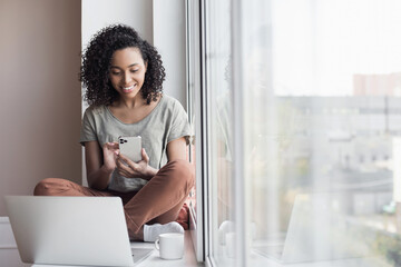 Sticker - Woman using smartphone and laptop, working at home. Student girl texting on mobile phone in her room. Communication, home work or study, connection, mobile apps, technology, lifestyle concept