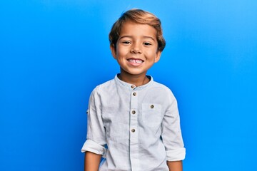 Adorable latin kid wearing casual clothes with a happy and cool smile on face. lucky person.