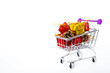 © Emir - Christmas and New Year shopping. Shopping cart full of gifts