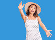 © Krakenimages.com - Young beautiful chinese girl wearing summer hat looking at the camera smiling with open arms for hug. cheerful expression embracing happiness.