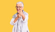 © Krakenimages.com - Senior beautiful woman with blue eyes and grey hair wearing casual clothes and glasses pointing fingers to camera with happy and funny face. good energy and vibes.
