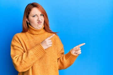 Poster - Beautiful redhead woman pointing fingers to the side skeptic and nervous, frowning upset because of problem. negative person.