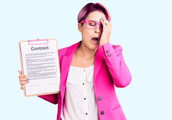 Sticker - Young beautiful woman with pink hair holding clipboard with contract document yawning tired covering half face, eye and mouth with hand. face hurts in pain.