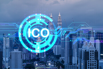 Initial coin offering hologram, night panorama city view of Kuala Lumpur. KL is the center of cryptocurrency projects in Malaysia, Asia. The concept of widespread ICO hysteria. Double exposure.