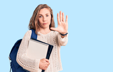 Sticker - Young beautiful blonde woman wearing student backpack holding notebook with open hand doing stop sign with serious and confident expression, defense gesture