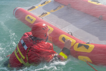 San Rafael, Argentina, november 6, 2020: firefighters in water rescue drill, using canoe and special suits