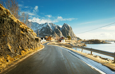 Wall Mural - road with snow mountains and fisherman village background, spring time, Reine, Lofoten, Norway