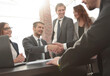 © ASDF - shaking hands after a business meeting in the office