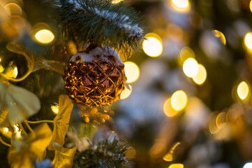 Christmas trees decorated with balls and lights, garlands on a city street, close-up.