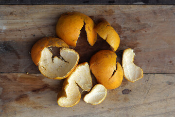 Orange peel on brown wood background