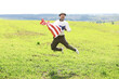 © alexkich - Man waving American flag standing in grass farm agricultural field , holidays, patriotism, pride, freedom, political parties, immigrant