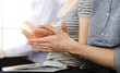© Iryna - Business people clapping at meeting or conference, close-up of hands. Group of unknown businessmen and women in sunny office