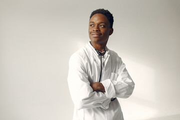 Black man on a blue background. Doctor with a stethoscope.