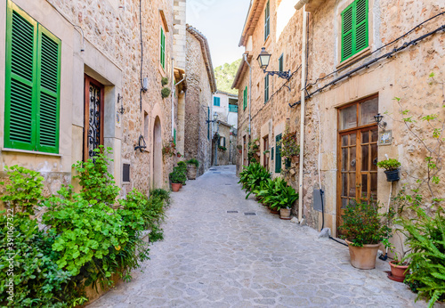 beautiful street with stone buildings decorated with flowers in Valldemossa old town, Mallorca island, Spain © r_andrei
