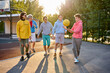 diverse young city boys are ready to play basketball together, sport club members have fun outdoors, in casual wear. portrait