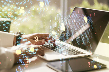 Double exposure of social network icons concept with world map and hand typing on computer keyboard on background. Networking concept