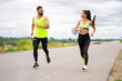 © Georgii - Beautiful young couple running on road in stylish sportswear on workout outdoor in cloudy weather, healthy lifestyle