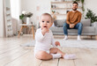 © Prostock-studio - Cute Little Baby And Father Sitting In Living Room Indoor
