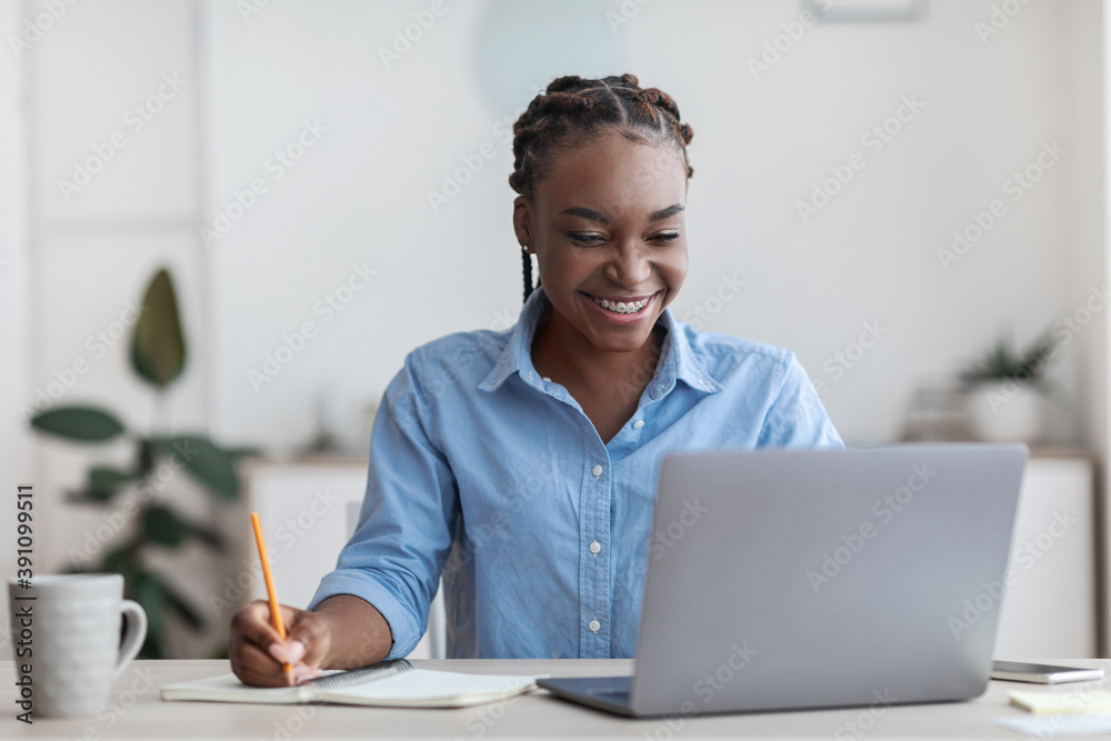 Online Education. Young Black Female Student Using Laptop At Home, Taking Notes - obrazy, fototapety, plakaty 