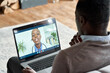 © insta_photos - Male black patient on conference video call with female african doctor. Virtual therapist consulting young man during online appointment on laptop at home. Telemedicine chat, telehealth concept.