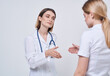 © SHOTPRIME STUDIO - Professional doctor woman shakes hand of a female patient on a light background
