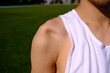 sportsman with shoulder dislocation in turf/sports field. shoulder bone is clarified. 
