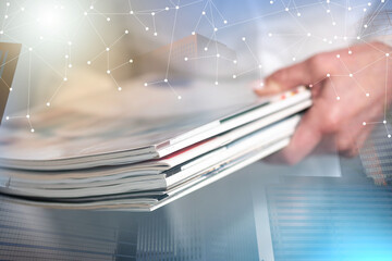 Female hands holding magazines; multiple exposure