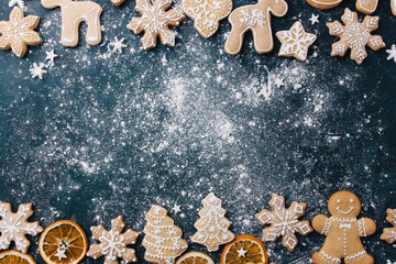 Wall Mural - Christmas composition, New Year greeting card. Mockup with festive food decorations and gingerbread cookies on blue background. Copy space.