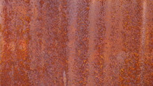 Old Rusted Steel Plate Background. Grunge Background Of Weathered Red Brown Metal Surface Due To Its Chemical Reaction With Water And Air. Selective Focus