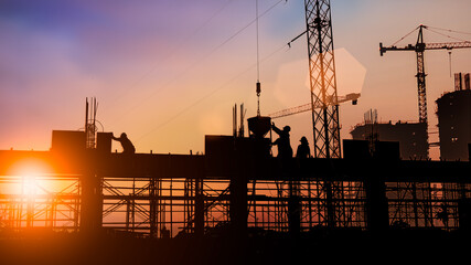 Wall Mural - Silhouette of Survey Engineer and construction team working at site over blurred  industry background with Light fair Film Grain effect.Create from multiple reference images together