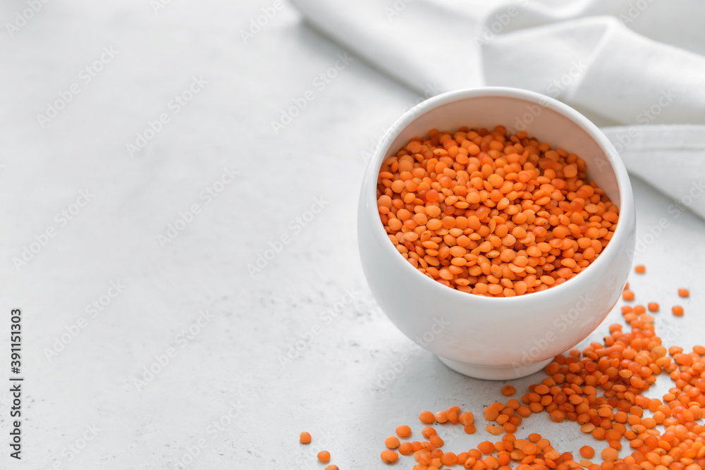 Bowl with raw lentils on light table