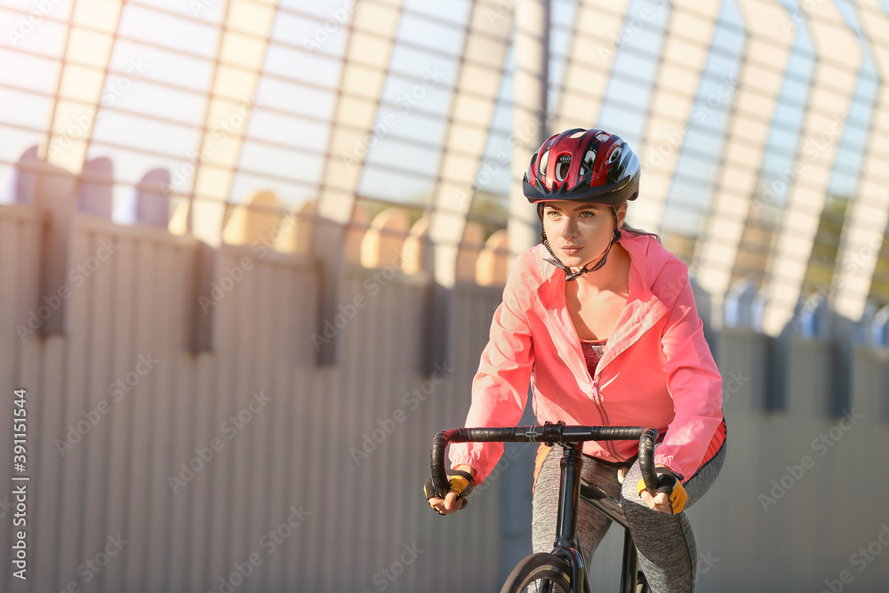 Female cyclist riding bicycle outdoors