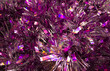 violet sparkling tinsel macro texture for a Christmas and New Year background. Shiny bright background with glitter closeup.