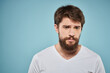 © SHOTPRIME STUDIO - Bearded man emotions white t-shirt lifestyle gestures with hands blue backgrounds