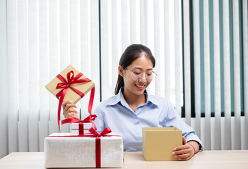 Asian women happy to open surprise box are stunned with excitement, joy and smile on holidays, Christmas, birthday or Valentine's Day concept