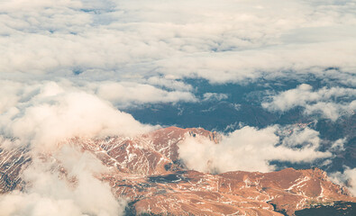 aerial airplane view over bucegi mountains in romania with mixed autumn winter landscape between the