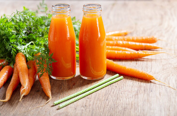 Wall Mural - bottles of fresh carrot juice