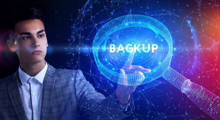 Business, Technology, Internet and network concept. Young businessman working on a virtual screen of the future and sees the inscription: Backup