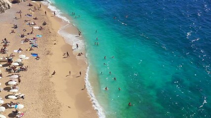 Wall Mural - Kaputas beach, Turkey. Beautiful turquoise beach with sun loungers and tourists in a Turkish resort in summer