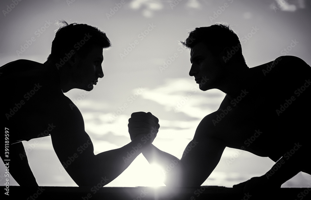 Rivalry, vs, challenge, hand wrestling. Sunset, sunrise. Silhouette of ...