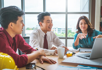 Wall Mural - Three contractor builder team having a successful meeting in office.