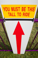 Height Requirment Sign In Front Of Amusement Park Ride
