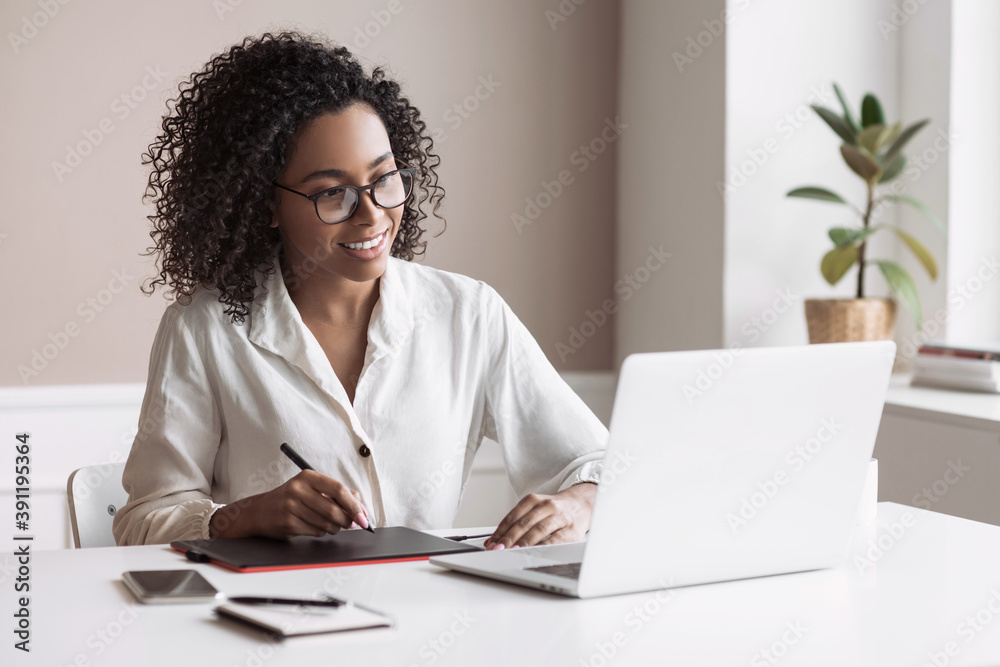 Young woman using laptop computer at office. Student girl working at home. Work or study from home, freelance, business, lifestyle concept
