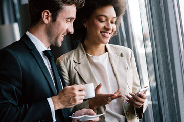 Poster - Two young businesspeople having a successful meeting at restaurant.